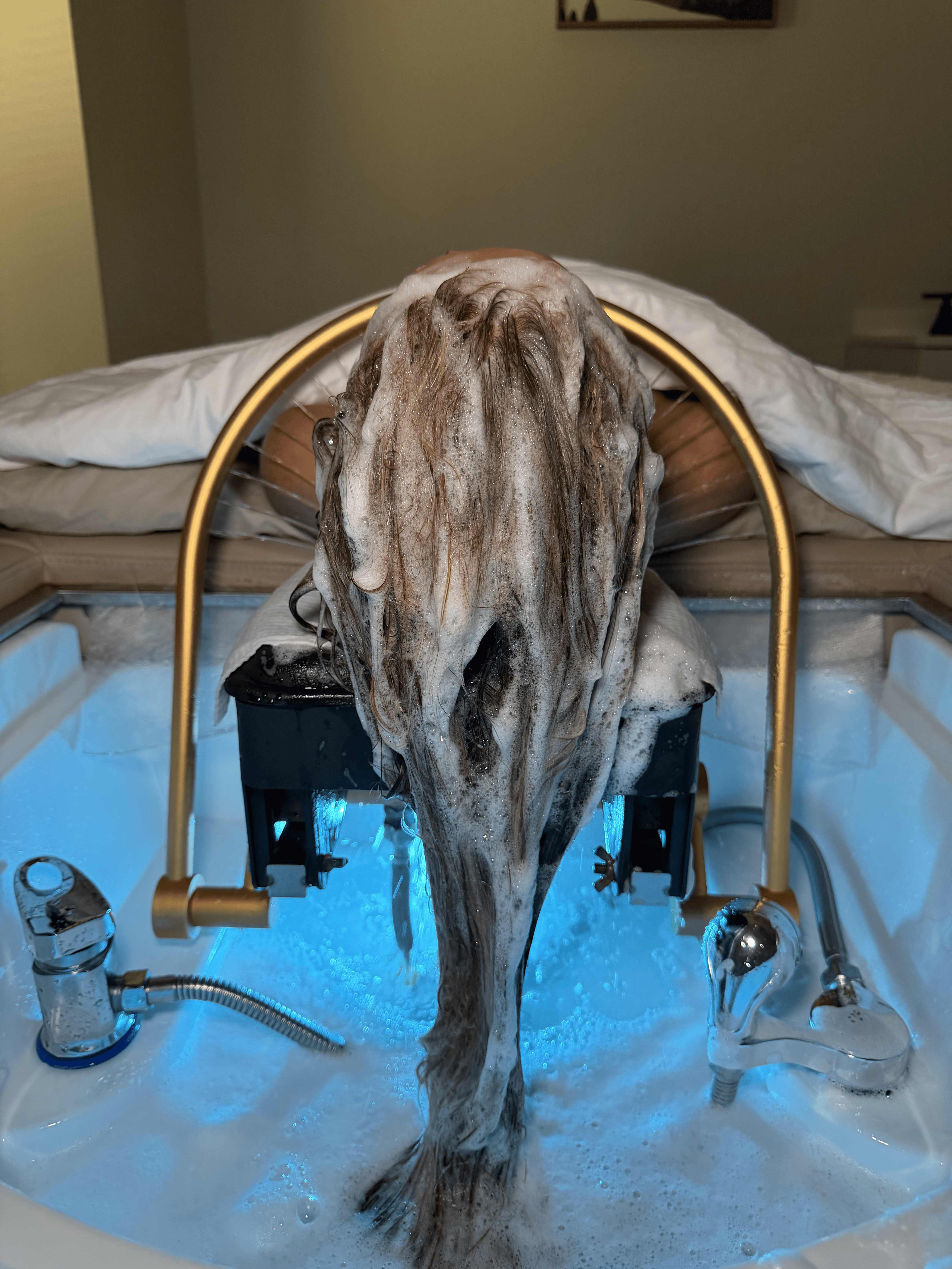 Japanese Head Spa cleansing ritual with rich foam at the gold water halo basin — 4Hands in Charlotte