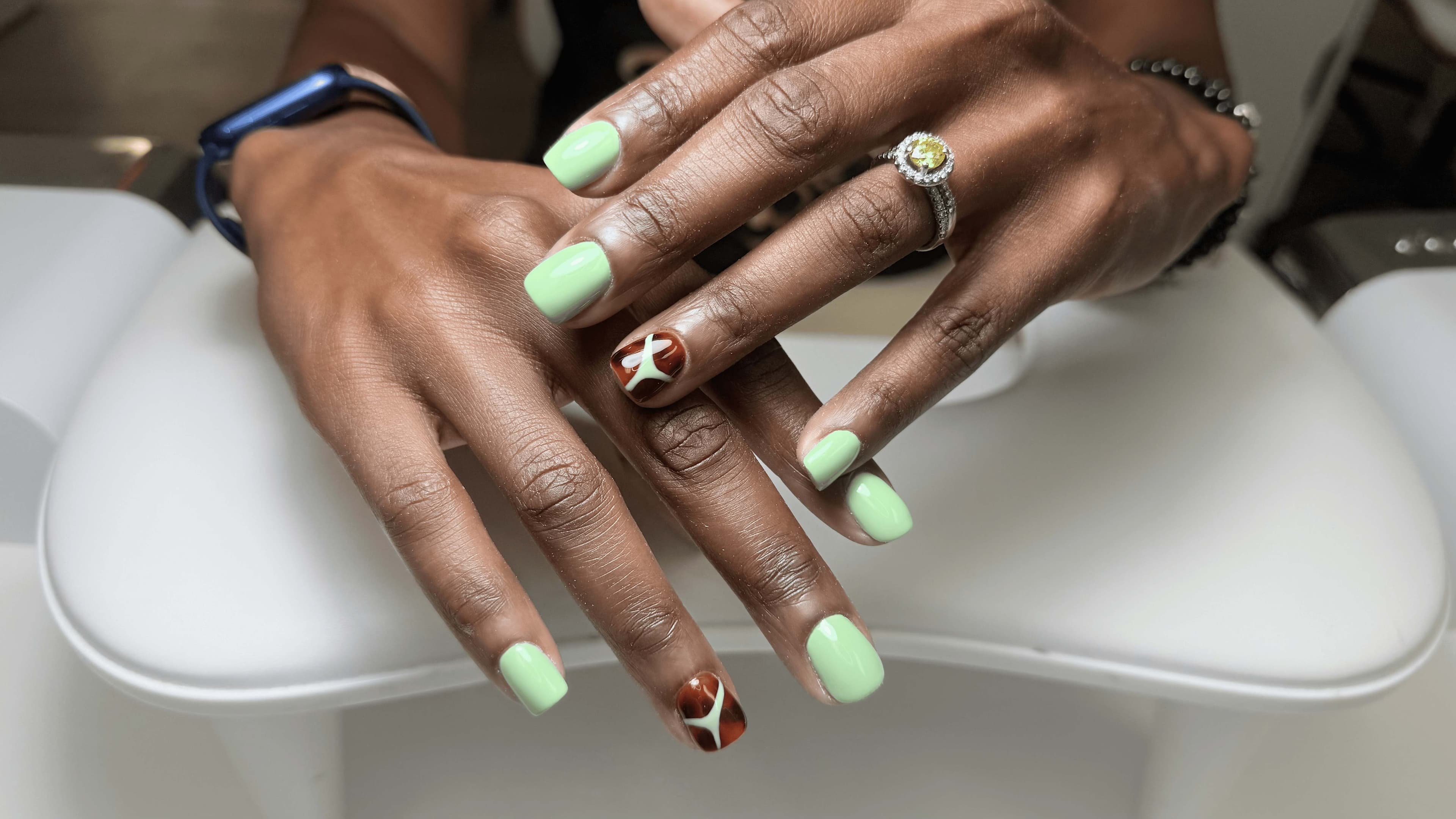 Mint pistachio gel manicure with mocha abstract accent nails at 4Hands in Charlotte