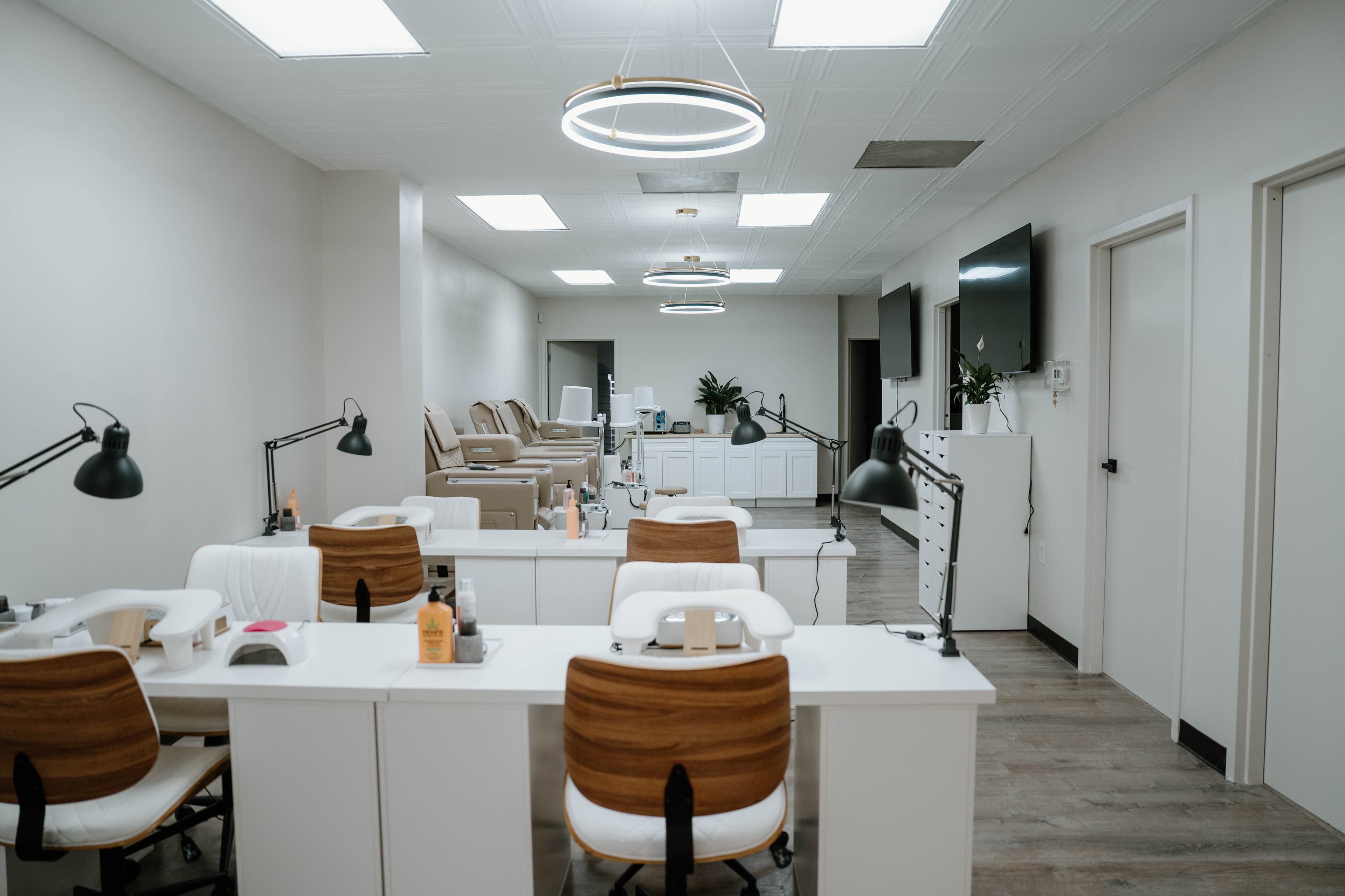Bright salon interior with manicure tables and pedicure chairs at 4Hands in Charlotte