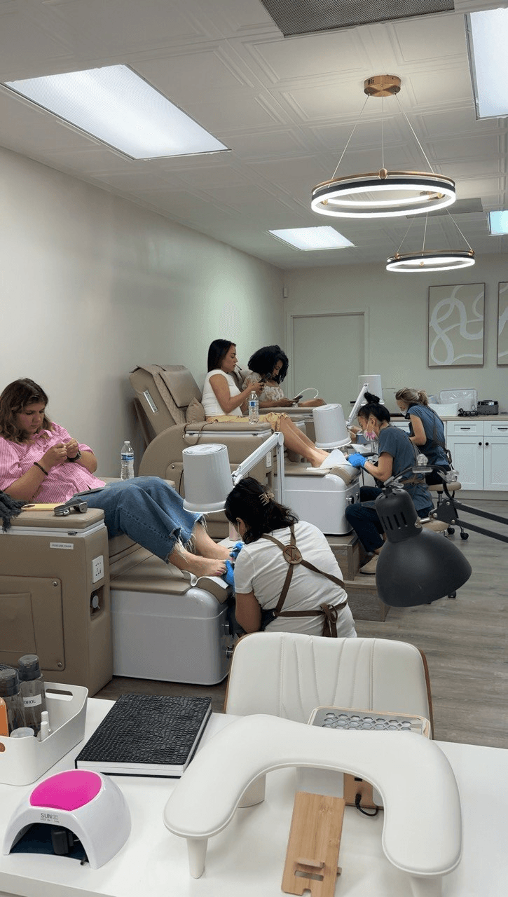 Guests enjoying manicures and pedicures in the bright 4Hands studio in Charlotte